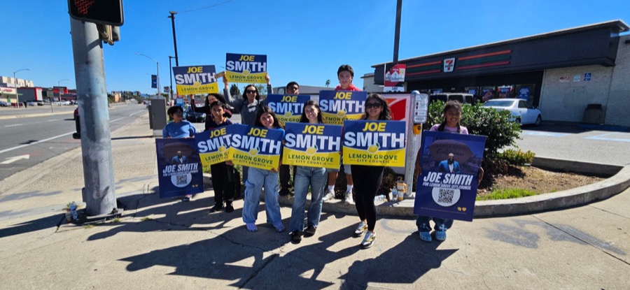 Volunteers waving Joe Smith campaign signs