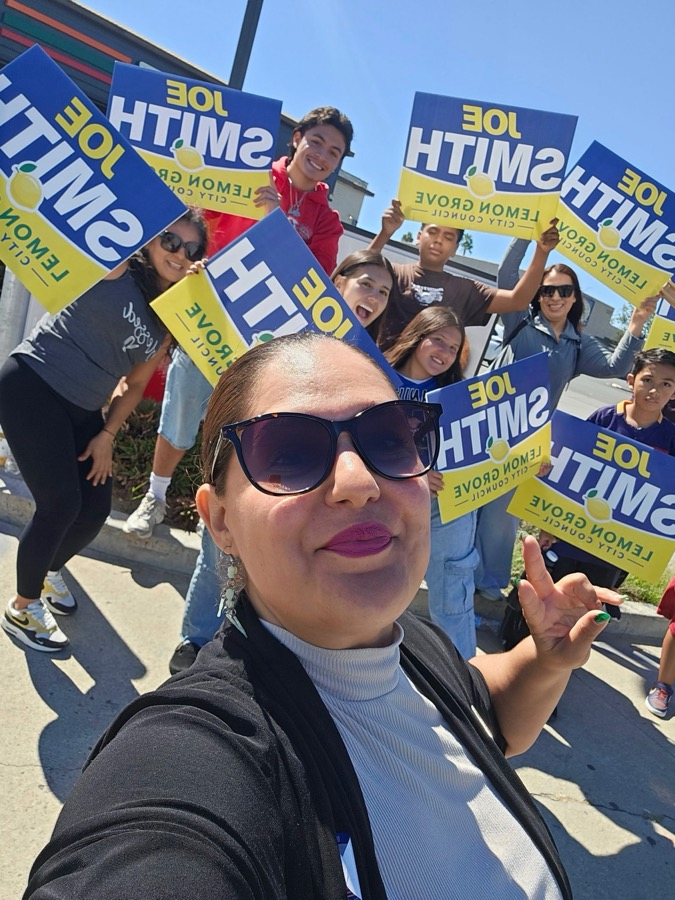 Volunteers holding Joe Smith signs on a street corner