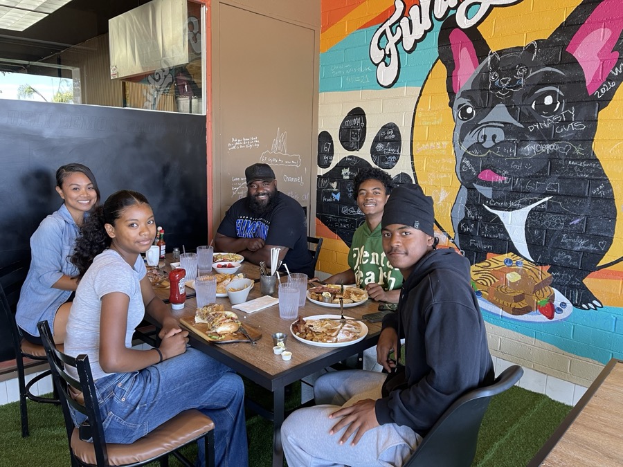 Joe Smith with families sharing a meal